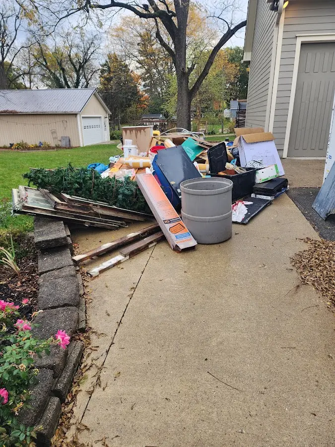 Dumpster being loaded with debris for 10 Yard Dumpster Rental in Huron
